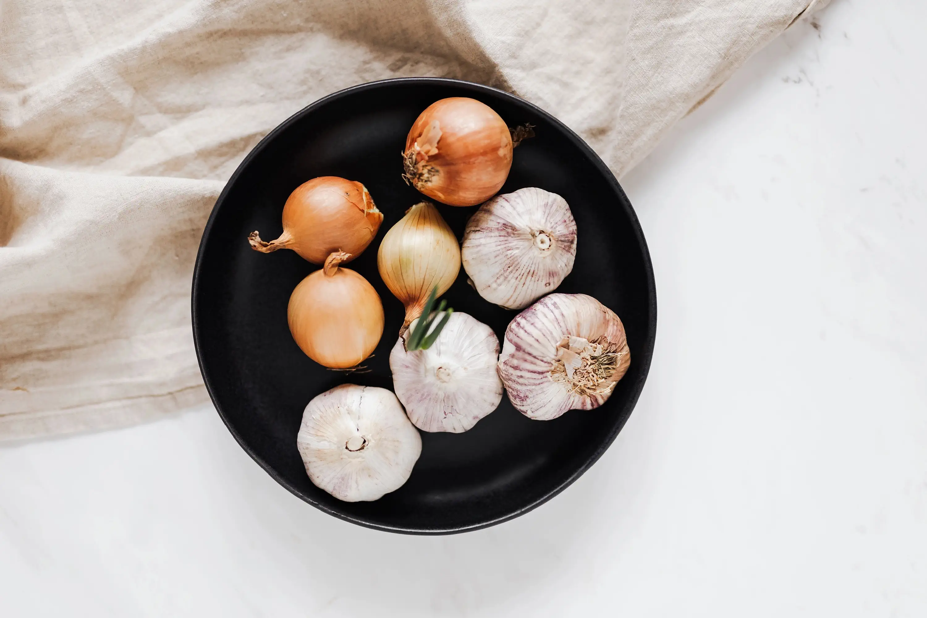 bowl filled with garlic and onions